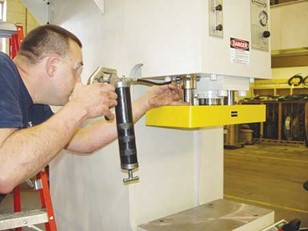 Technician performing routine maintenance on a machine